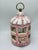 A whimsical French porcelain birdcage featuring an elegant domed top surmounted by a brass ring handle. The cage is...