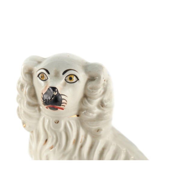 Pair of Victorian antique white Staffordshire Dogs in the seated position, hand painted faces and gilt decoration.