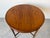 Elegant antique French round side table crafted from solid wood with a stunning flame mahogany top showcasing rich natural...