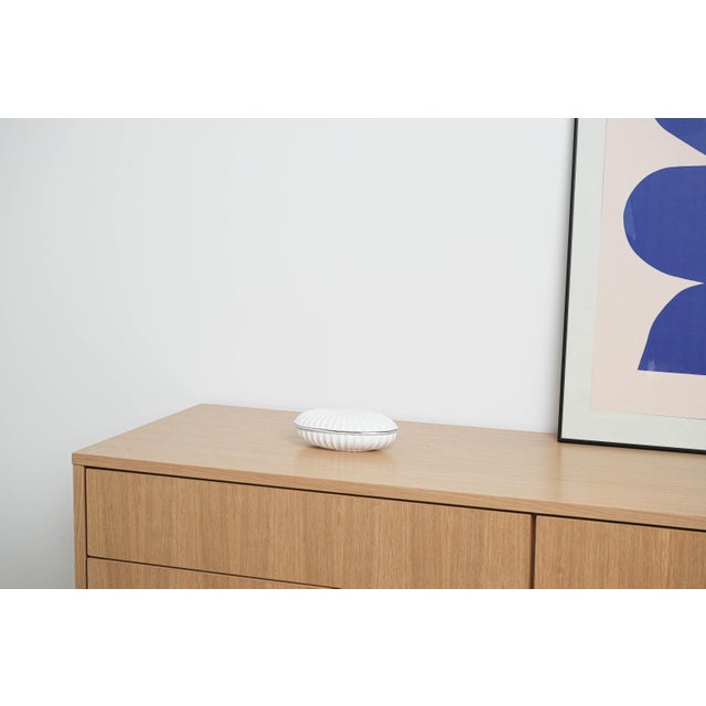 The porcelain box was made in the 1970s in Italy. An elegant porcelain box with a streamlined shape inspired by a shell,...