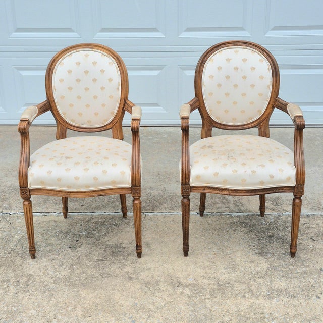 This pair of Louis XVI style open arm chairs by Century Furniture combines heirloom quality American craftsmanship with a...