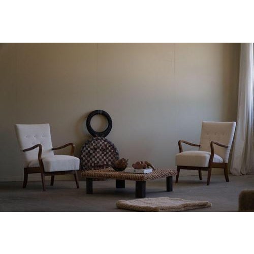 A classic pair of Danish mid-century modern lounge chairs from the 1960s, featuring solid beech wood frames and...