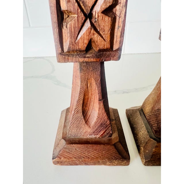 This pair of vintage wooden candleholders feature a dark stained wood with a rustic carving style. The design incorporates...