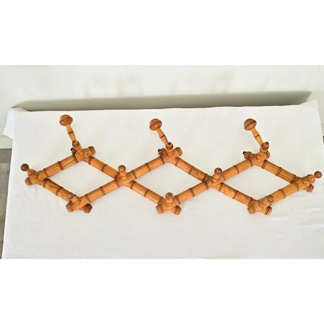 Dimensions: 20 ½” H x 36” W x 7 ¼” D Delightful French late 19th century faux-bamboo (carved pine) expanding hat & coat...