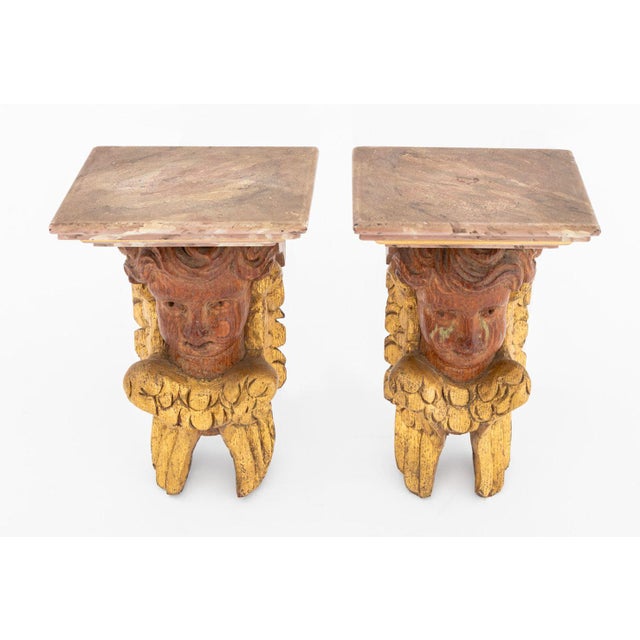 Pair of Faux Marble Carved Giltwood Cherub Wall Brackets, late 19th century. 8" H x 4.75" W x 4" D. Provenance: The Upper...
