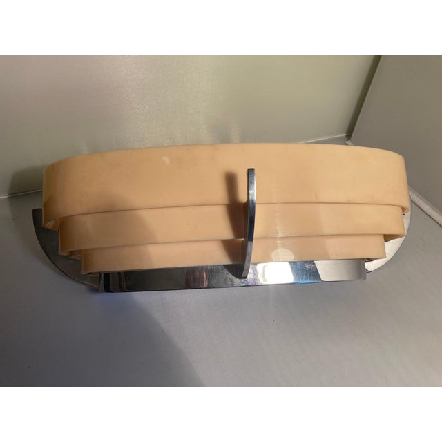 1 rare set of three exceptional Art Deco wall lamps. United Kingdom 1930. The chrome-plated frame is probably based on a...