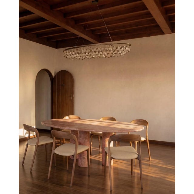 This minimalist table is made from one material, a high quality Red Travertine. Featuring a curved edge top that elegantly...