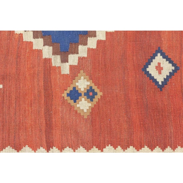 The nicely abrashed red field is dominated by a pole medallion of three conjoint nested stepped diamonds in light yellow...