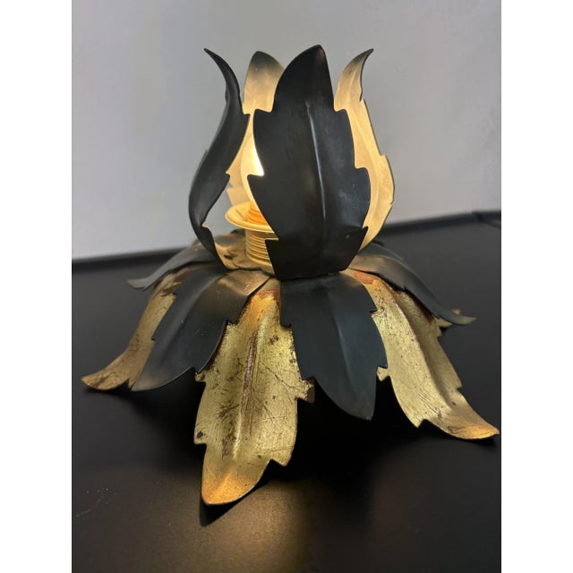 This is a vintage Florentine ceiling or wall lamp from the 1970s. It features a unique leaf design with a black and gold...
