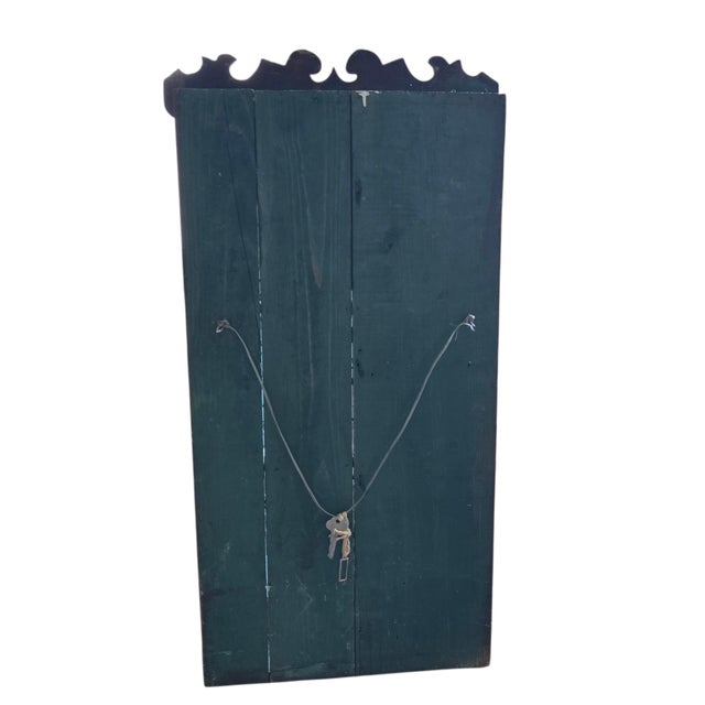 A wonderful antique wall cabinet, wood construction with a distinct scrolled pediment (decorative crown) and a single...