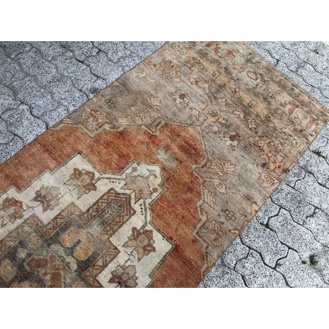 This is a vintage Turkish Oushak rug from the 1960s. The piece was hand-knotted.