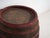 This antique wooden barrel with iron hoops features a wide cylindrical body of oak staves held by hand-forged iron hoops...