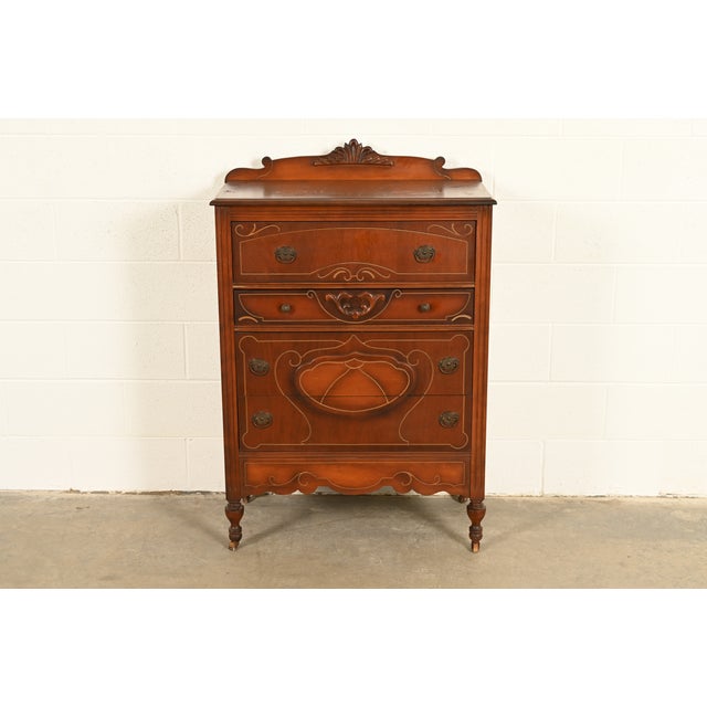 A beautiful antique Art Deco highboy dresser In the manner of Berkey & Gay USA, Circa 1930s Carved walnut, with original...