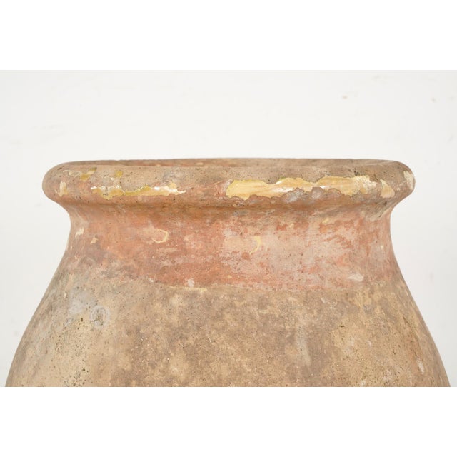 19th century olive jar made of blond terra cotta clay with an ochre glaze. It was made in Biot, Provence, France, where...