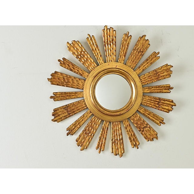 Resembling an aster flower or a twinkling star, this 19th century Italian sunburst mirror is a fine addition to a powder...