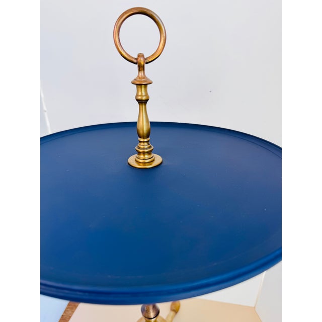 The newly painted blue color adds a fresh updated look to this fabulous cocktail table with a brass pedestal base. The...