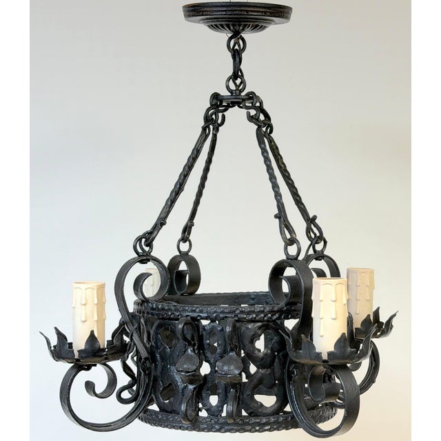 Addison Mizner Style Spanish Colonial Wrought Iron Four-Light Chandelier This diminutive Spanish Colonial Revival wrought...
