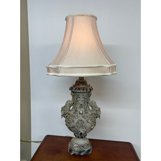 Design Plus Gallery presents a Vintage Style Table Lamp. Embellished with dolphin and shell motifs from top to bottom,...