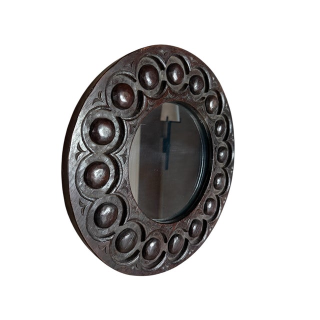 Handsome hand-carved walnut mirror from the Georgian era in England. Recessed circles with dart borders framing on both...