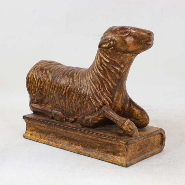 This charming vintage decorative piece is meticulously hand-carved from natural wood, featuring a serene recumbent lamb...