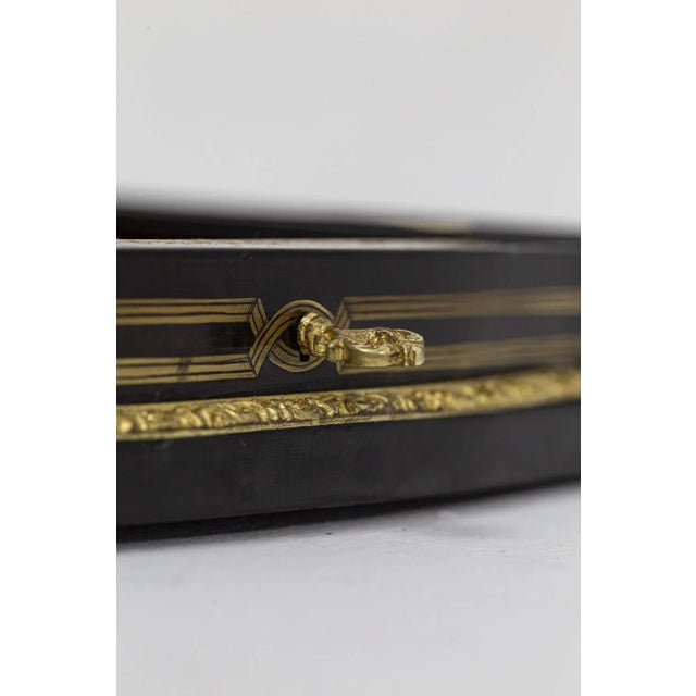 Game box in lacquered wood marquetry and gilt brass, with tokens inside. Gilding on the extremities of the spiral shape...