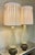 This pair of elegant mid-century Murano glass table lamps features a ribbed, teardrop-shaped hand-blown glass body resting...