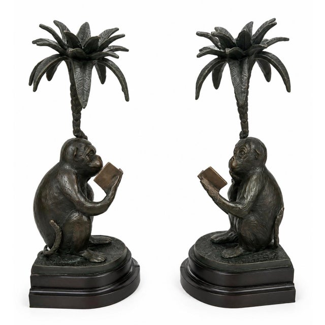 Presenting a highly decorative and whimsical pair of vintage cast metal candle holders, featuring finely detailed monkeys...