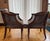 A beautifully crafted pair of vintage cane-back barrel armchairs in a classic French Regency / Hollywood Regency style,...