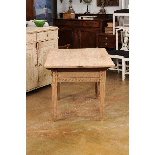 A French Napoléon III period Alsatian wooden center table from the mid 19th century, with carved stacked-coin style...