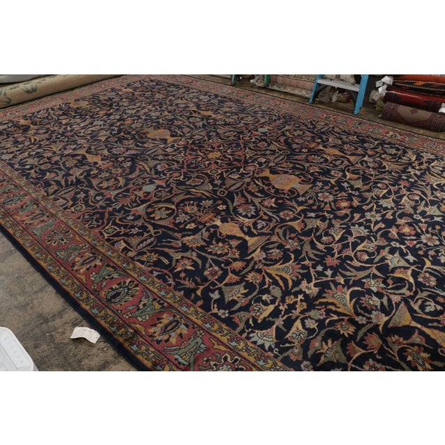 Hand-knotted in wool, this 12x19 oversized Antique Shahrestan rug features a play of all-over and medallion style, with...
