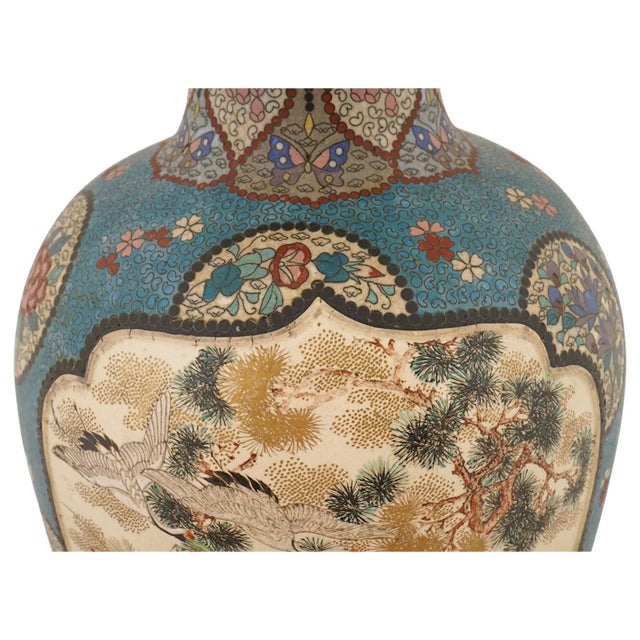 A monumental Japanese cloisonné enamel and ceramic vase dating to the late Meiji period, circa 1890 to 1912. Standing 22...