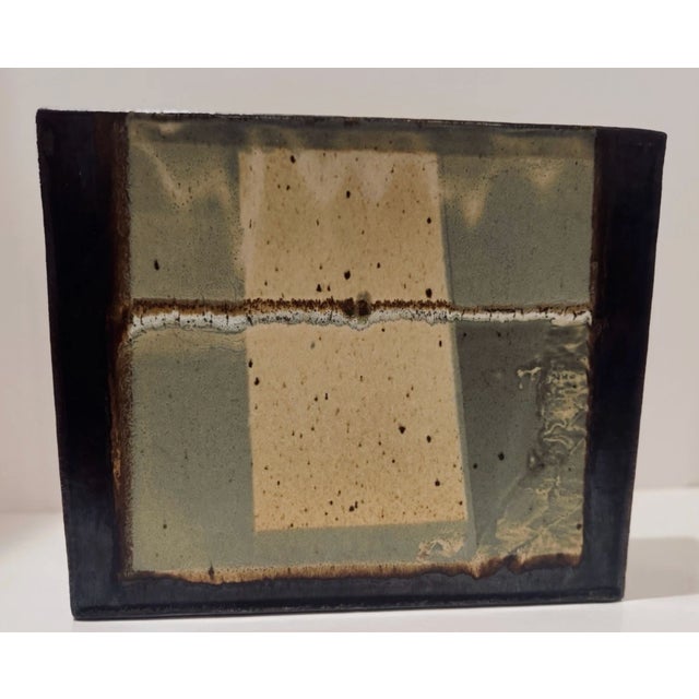 Hand-built ceramic sculpture by Don Penny featuring a minimalist geometric composition in soft earth-toned glazes. The...