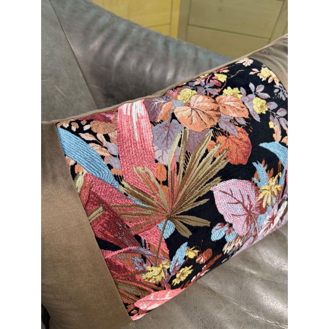 A lumbar cushion cover built around contrast: a dense tropical jacquard panel runs across the center, packed with...