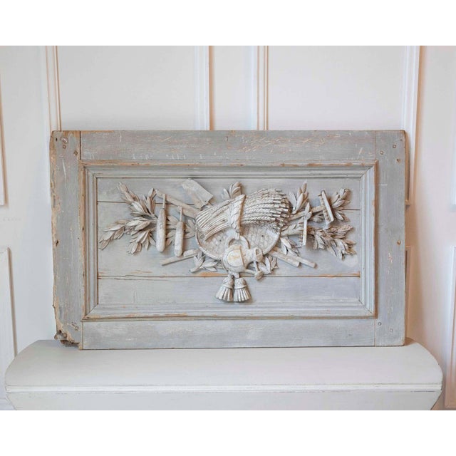 This elegant French wood panel dates from the Louis XVI period and features finely carved motifs symbolizing the...