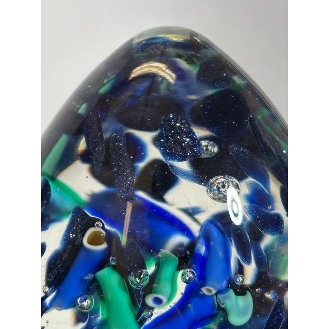 This Murano glass paperweight, produced in Italy in the 1990s, is formed as an egg-shaped sculptural object, combining...