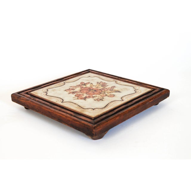 Footed Boho style wood framed tile trivet. Made in Italy. Minor age wear to wood. Makers mark on back.