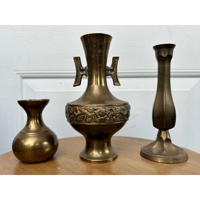 A trio of small brass vases. Dimensions listed are for the largest. One is marked made in Korea and another is marked made...
