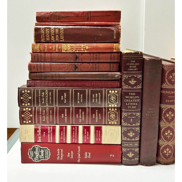 A curated set of vintage burgundy decorative books, ideal for creating a rich, layered library aesthetic. The varied tones...