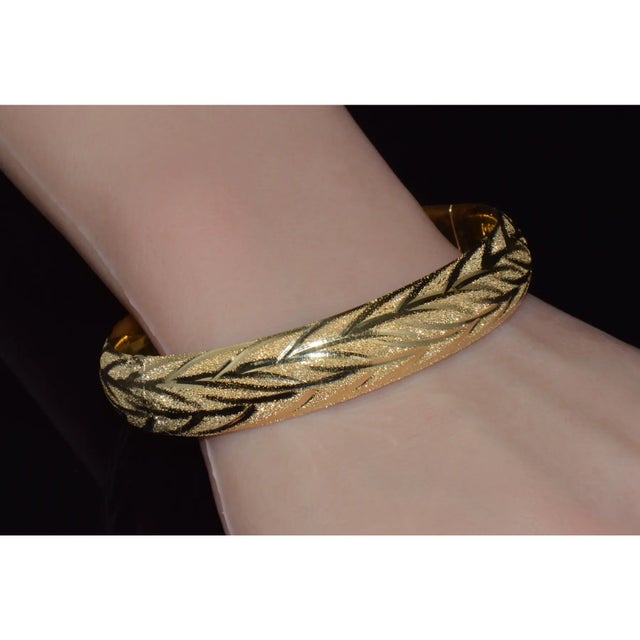 Gorgeous top quality 14K solid yellow gold openable hinged oval bangle bracelet. This open hinged oval bangle features a...