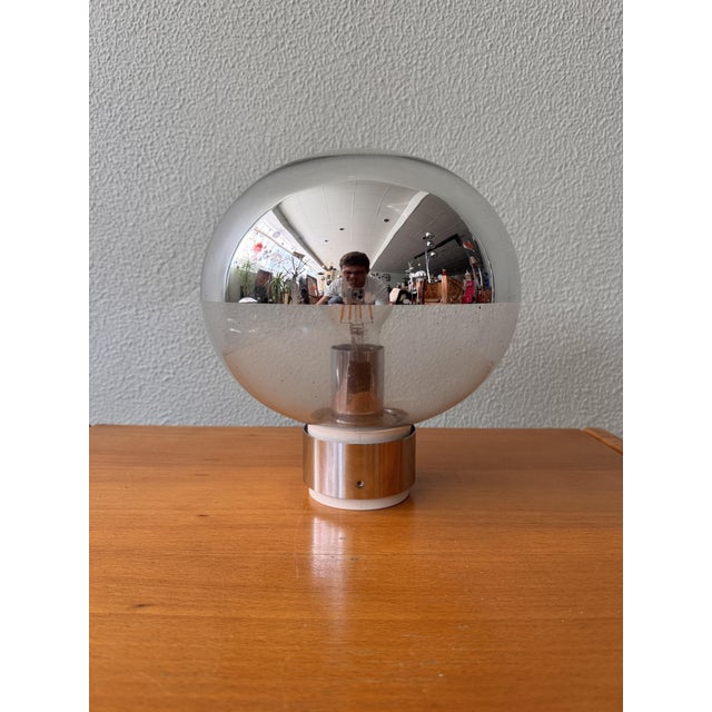 This exquisite sconce, designed by the renowned Japanese lighting designer Motoko Ishii for Staff Leuchten, is a beautiful...