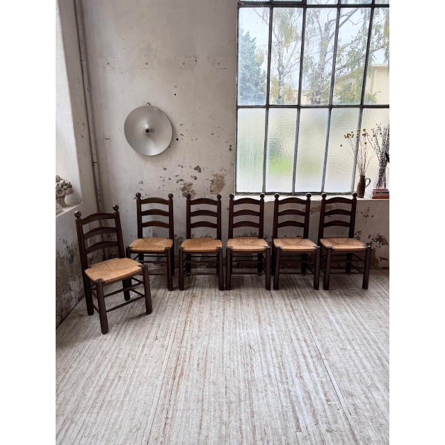 Vintage set of six solid oak chairs with straw seats, dating from the 1950s. In the style of charles dudouyt's designs, we...