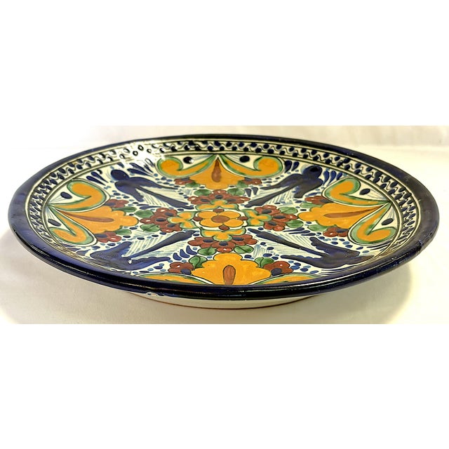 Colorful vintage hand painted terra cotta dish. Made in the Mexican Talavera style and painted in bright shades of blue,...