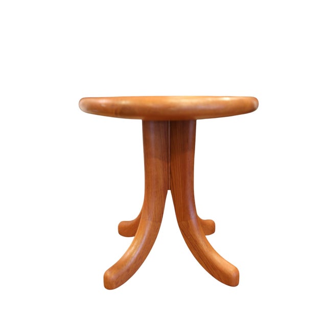 A wonderfully beautiful Danish stool from Dyrlund in solid teak, with soft shapes and an expressive base. The wood's...