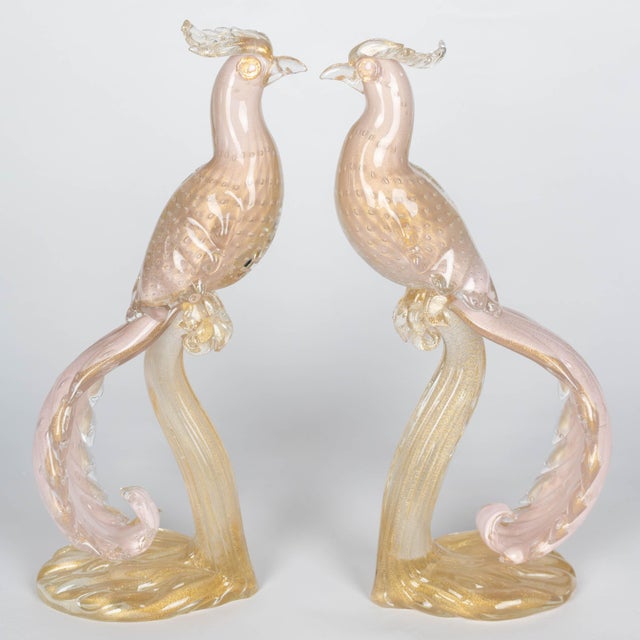 A pair of Mid-Century Murano handblown glass Birds-of-Paradise, by Alfredo Barbini. Beautiful pale pink color with gold...