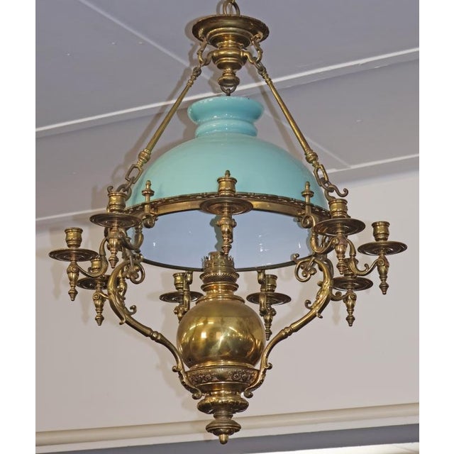 Late 19th Century Brass Kerosene Oil Chandelier with Blue Shade Dimensions : 26" Wide X 26" Deep X 32" Tall This...