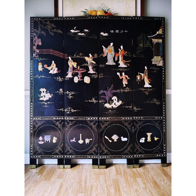 This is a beautiful Chinese Coromandel Four Panel Folding Screen with intricately carved hardstone of figural courtyard...