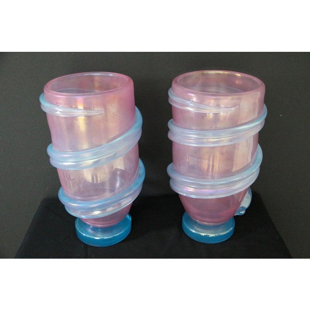 This pair of spectacular vases boasts a highly unusual pearly pink hue that shifts from deep pink to light, iridescent...