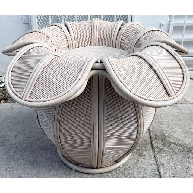 Pencil reed rattan bell flower dining table, featuring a unique, sculptural pedestal base made of woven rattan with a...