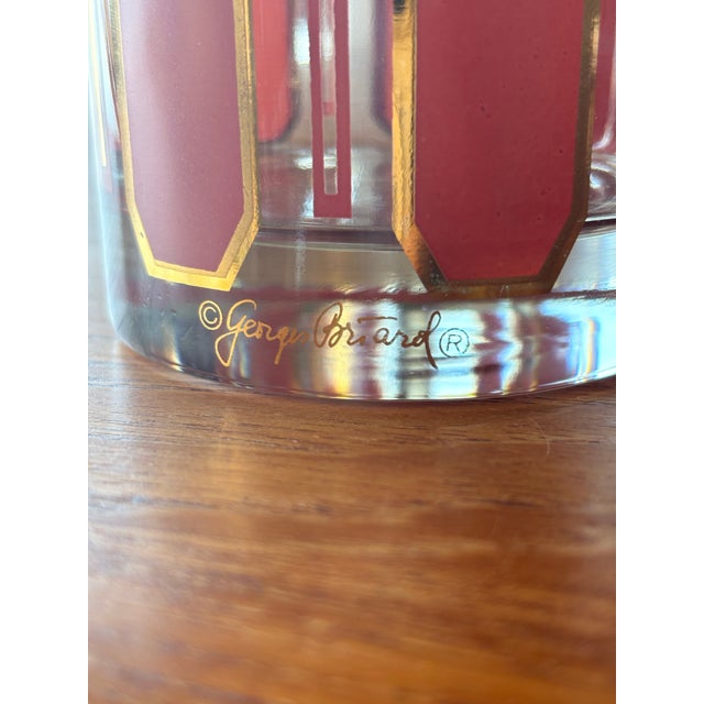Vintage mid-century modern lowball glasses feature vertical pinkish-red panels accented with 22-karat gold geometric trim...