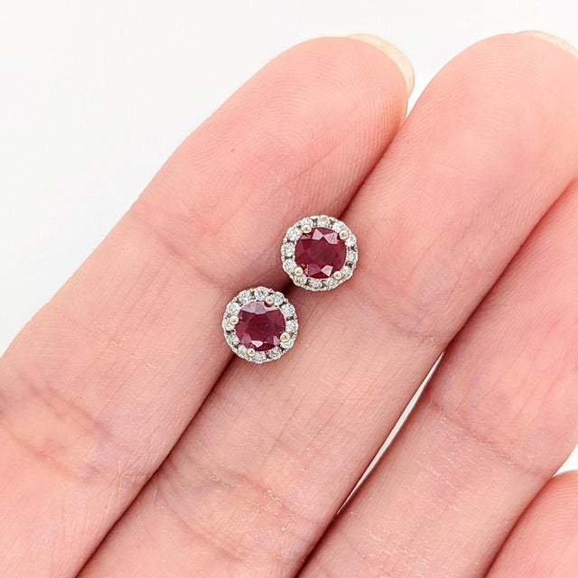 These dainty studs feature rich round Mozambique rubies surrounded by a halo of natural earth-mined diamonds, all set in...